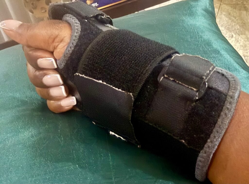 Hand wearing a wrist brace during carpal tunnel recovery