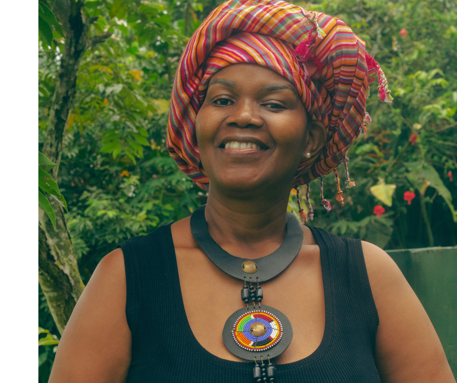 Jane smiling outdoors in a colorful headwrap